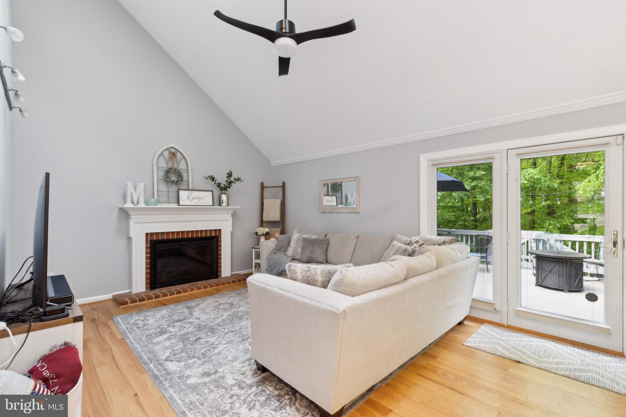 6724 Passageway Place Burke, VA 22015 - Photo 7 of 26 a living room with furniture and a fireplace
