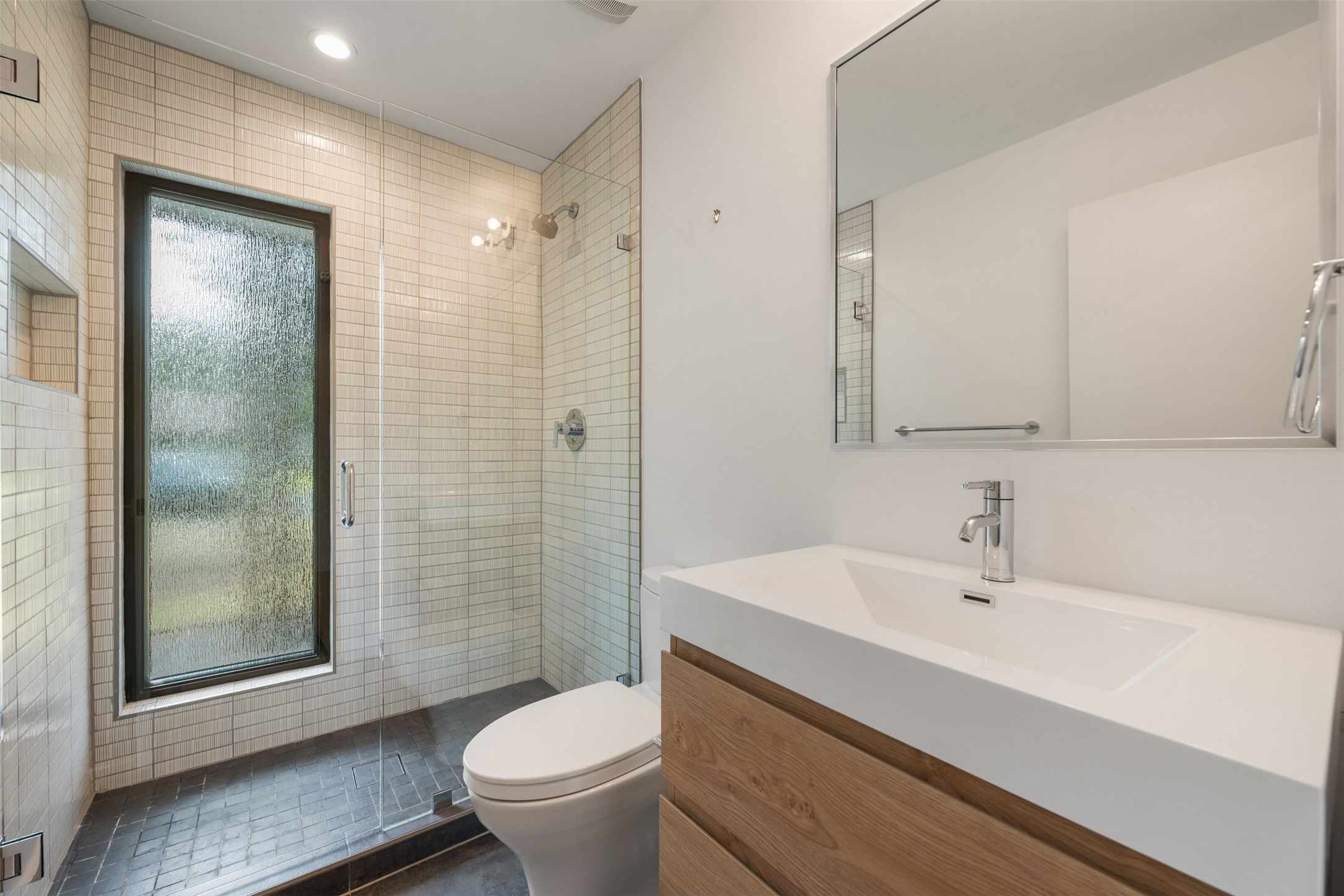 8900 Point W Drive Austin, TX 78759 - Photo 32 of 40 A well-appointed bathroom features a spacious glass-enclosed shower and a sleek vanity.