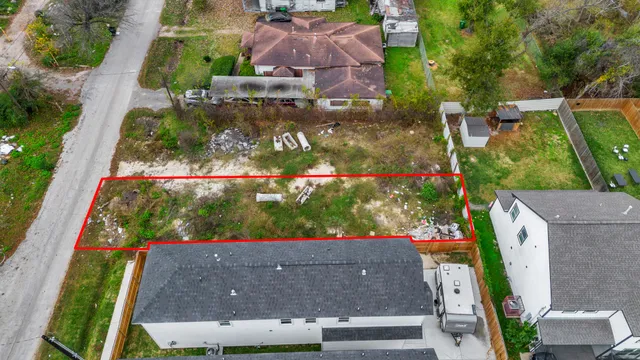 an aerial view of house with a yard and large trees