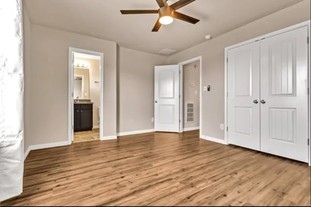 a view of an empty room and wooden floor