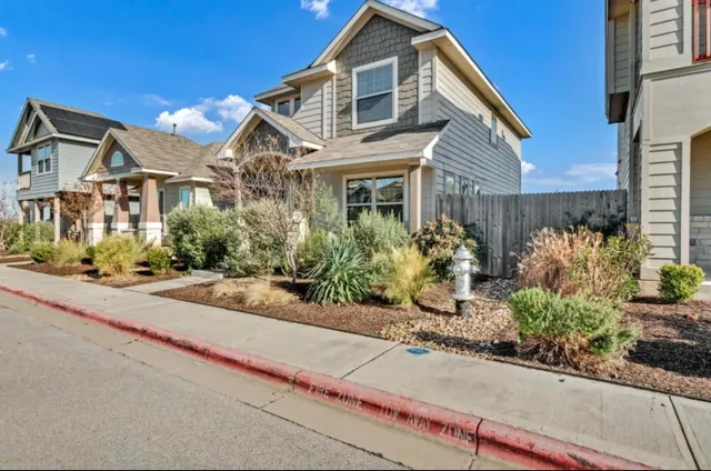 a front view of a house with a yard and a garage