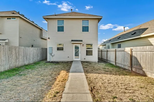 a view of a white house with a yard