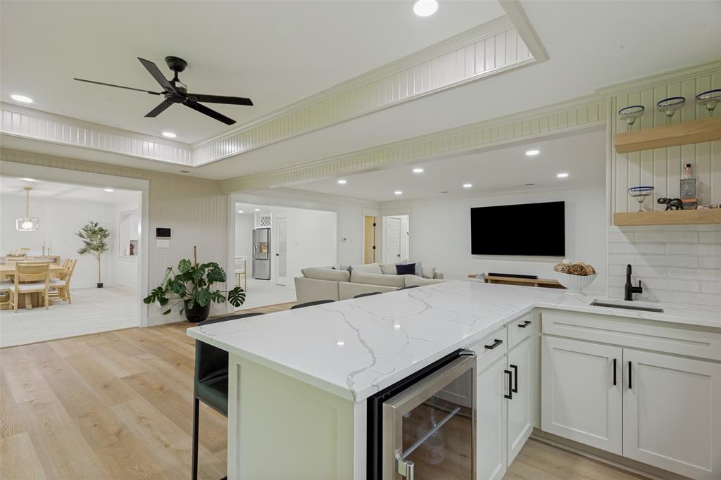 4316 Springbranch Drive Benbrook, TX 76116 - Photo 14 of 39 Contemporary wet bar featuring a quartz countertop, integrated beverage refrigerator, and white subway tile backsplash