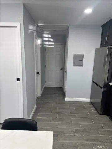a view of a hallway with wooden floor