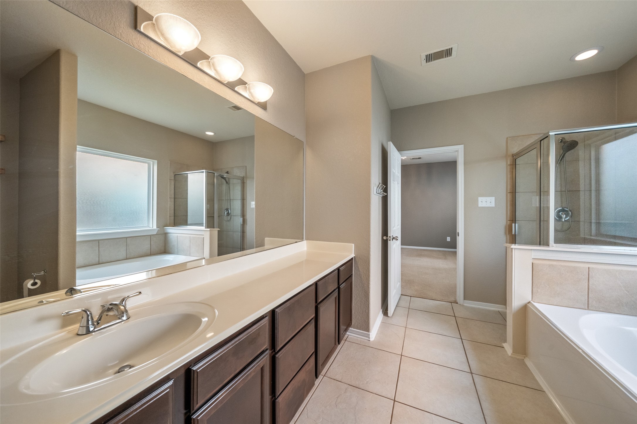 28915 Birch Green Way Spring, TX 77386 - Photo 17 of 30 a spacious bathroom with a granite countertop sink mirror and bathtub