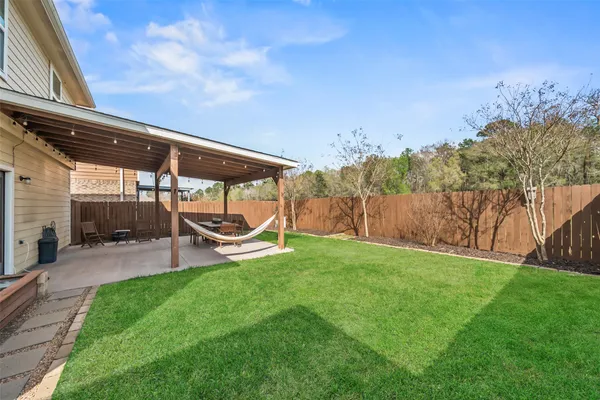 a view of a backyard with plants and a patio
