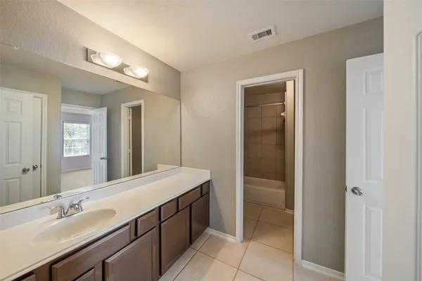 a bathroom with a double vanity sink a and mirror