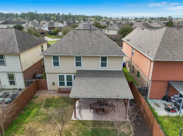 an aerial view of a house with a yard balcony