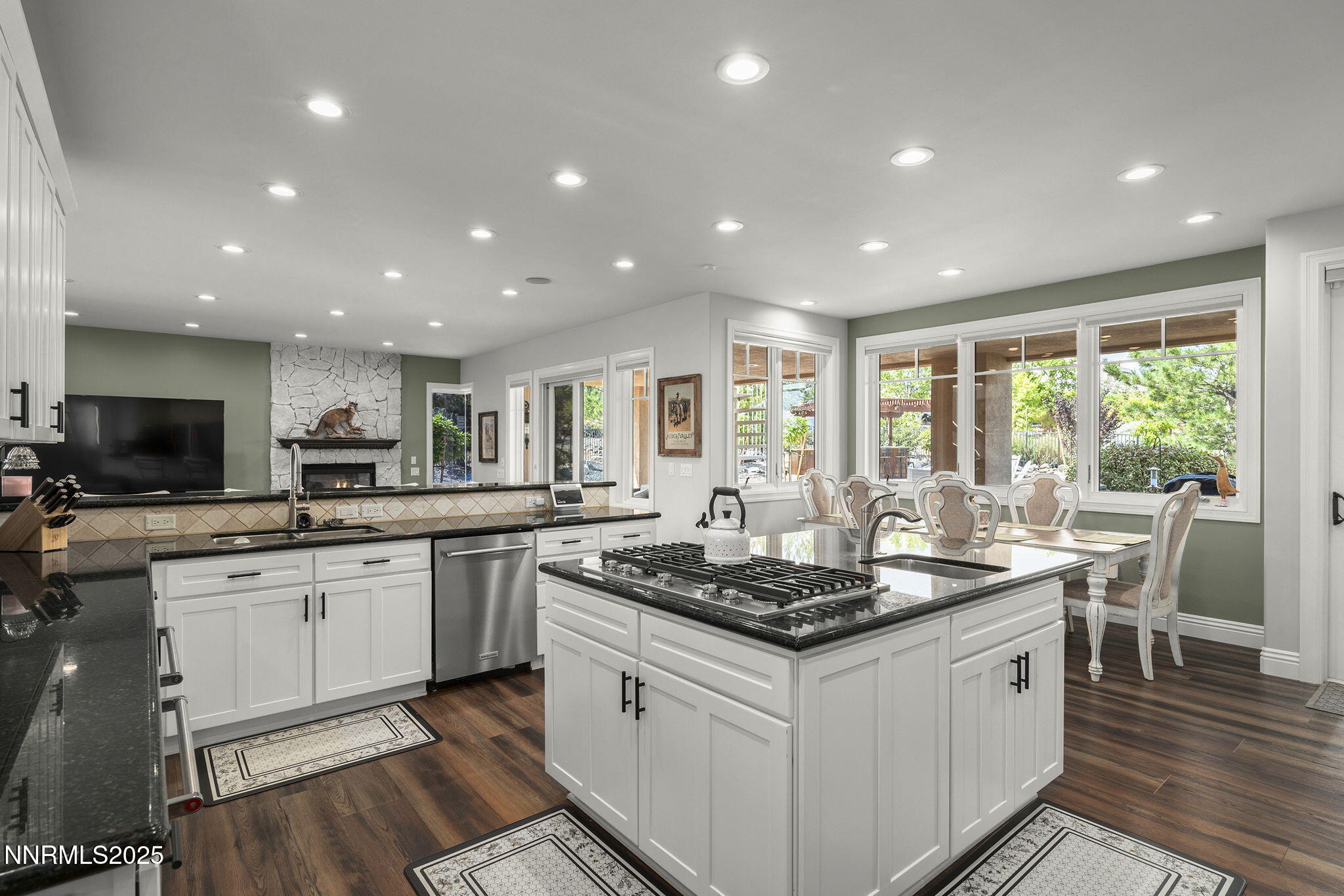 1465 Taos Lane Reno, NV 89511 - Photo 16 of 60 a kitchen with stainless steel appliances granite countertop stove top oven and cabinets