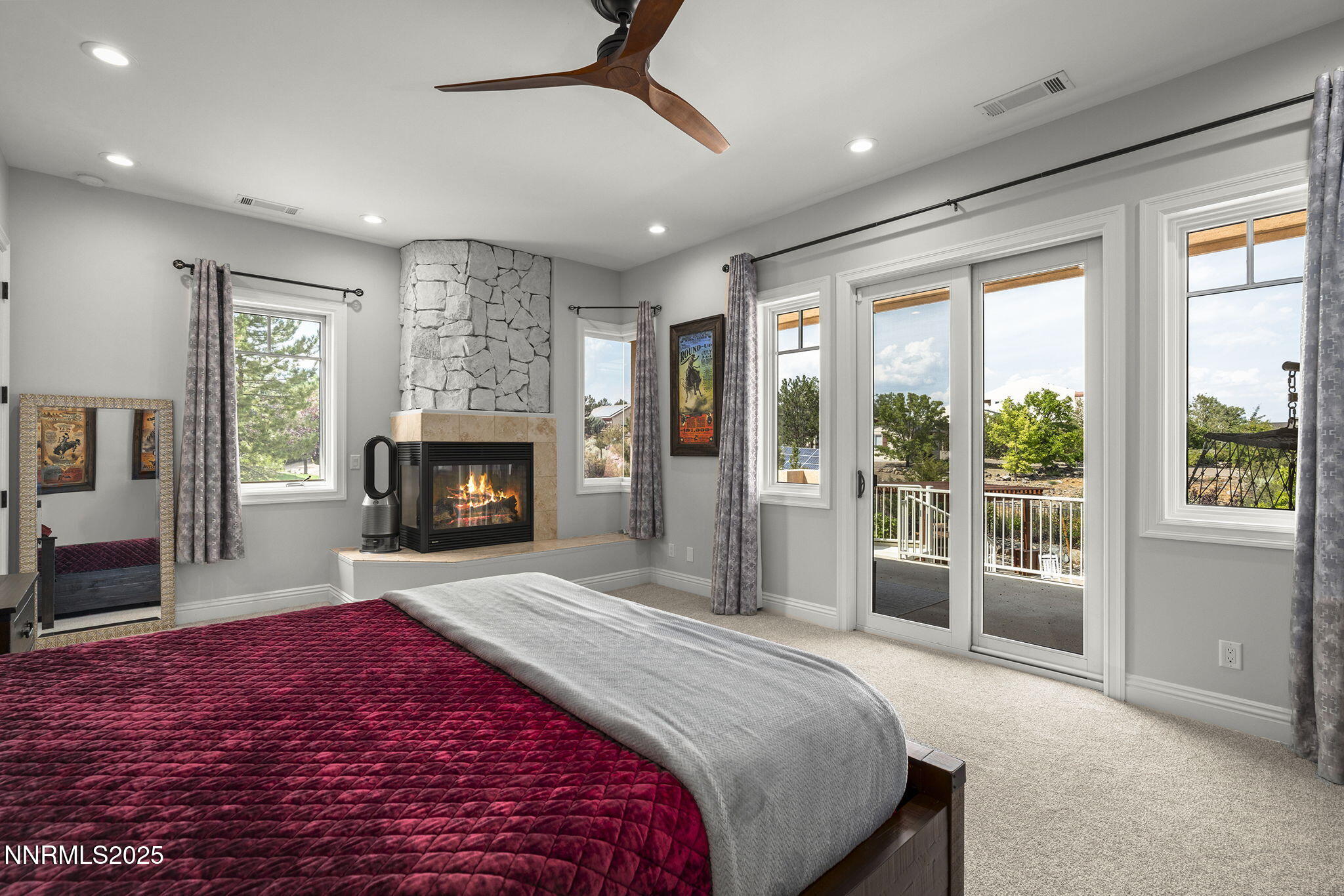 1465 Taos Lane Reno, NV 89511 - Photo 26 of 60 a spacious bedroom with a large bed and a fireplace