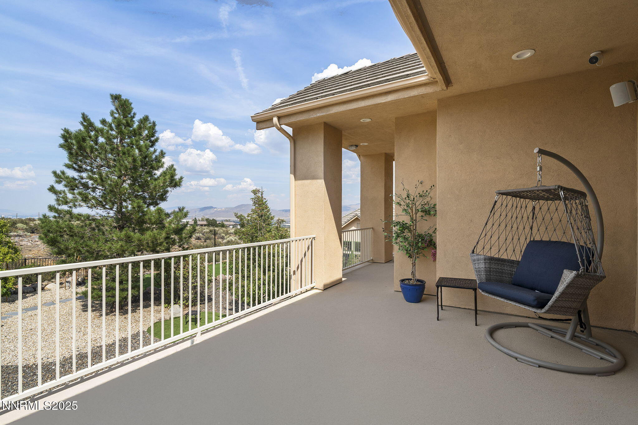 1465 Taos Lane Reno, NV 89511 - Photo 30 of 60 a view of a balcony with chair and potted plants