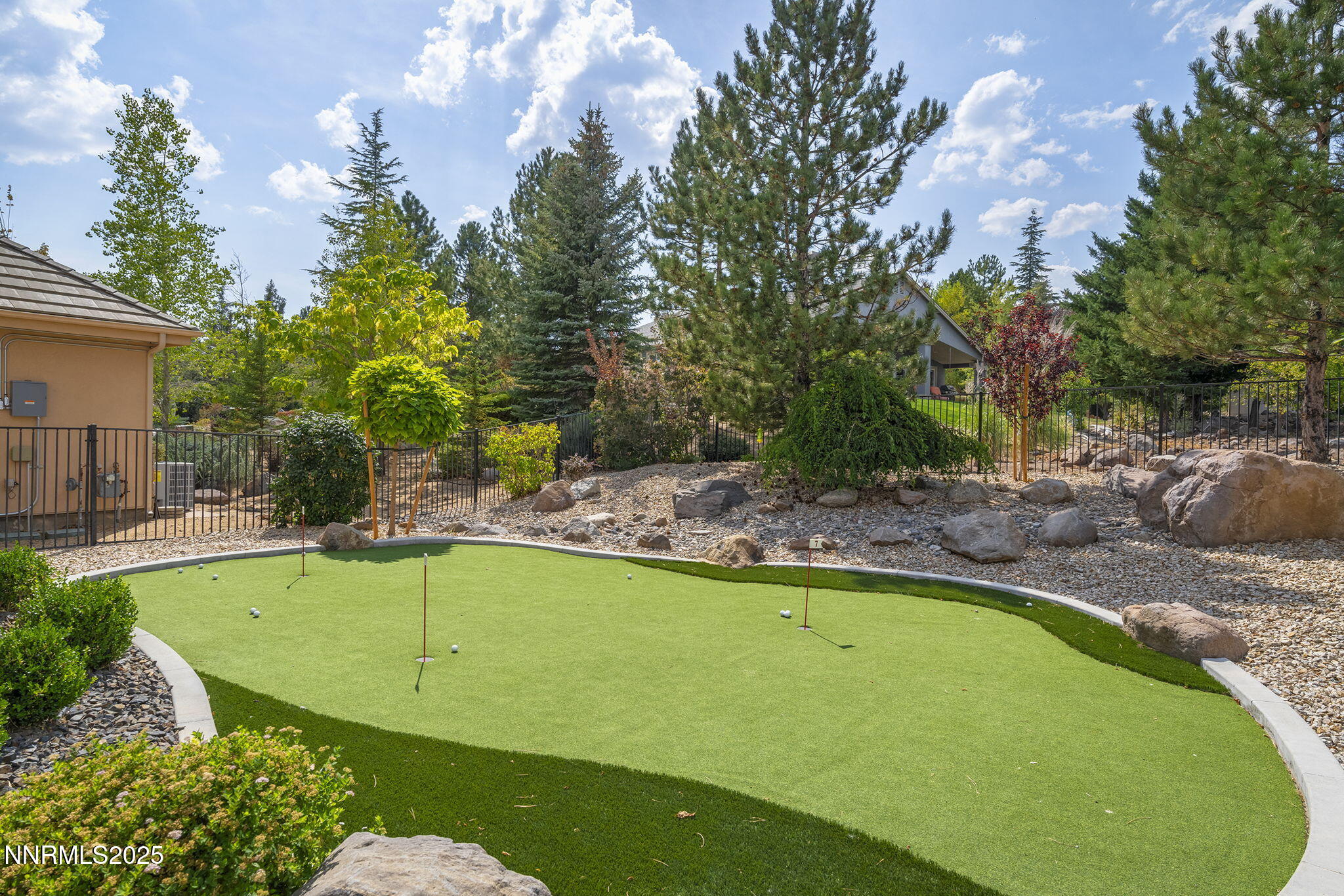 1465 Taos Lane Reno, NV 89511 - Photo 46 of 60 a view of a swimming pool with a bench and trees in the background