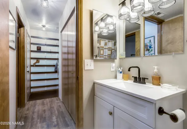 a bathroom with a sink a mirror and shower