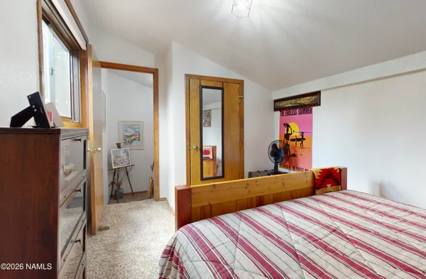 a bedroom with a bed and a dresser