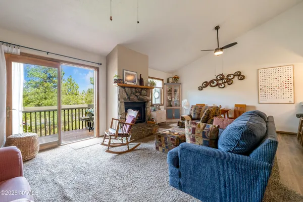 a living room with furniture a floor to ceiling window and a flat screen tv