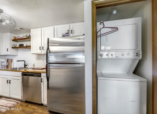 a kitchen with a refrigerator sink and cabinets