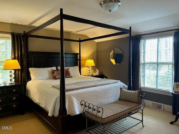 a bedroom with a bed and window