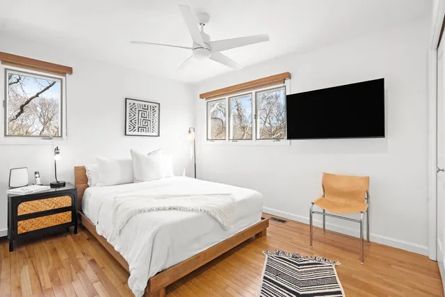 a bedroom with a bed and a flat screen tv