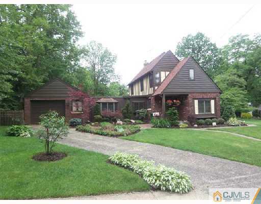 439 Chain O' Hills Road Colonia, NJ 07067 - Photo 2 of 10 a front view of a house with a yard and porch