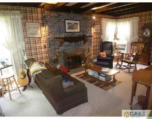 439 Chain O' Hills Road Colonia, NJ 07067 - Photo 7 of 10 a living room with furniture and a fireplace