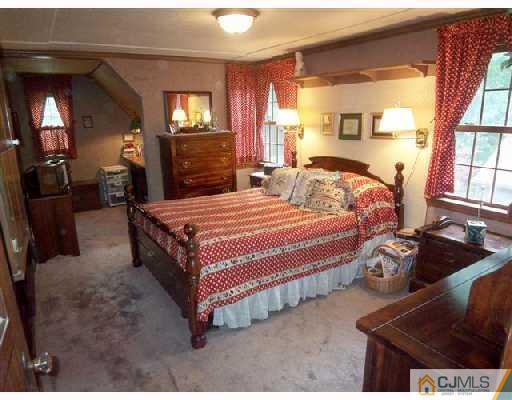 439 Chain O' Hills Road Colonia, NJ 07067 - Photo 8 of 10 a bedroom with a bed and window