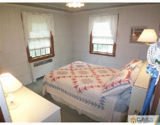 439 Chain O' Hills Road Colonia, NJ 07067 - Photo 9 of 10 a bedroom with a bed and a window