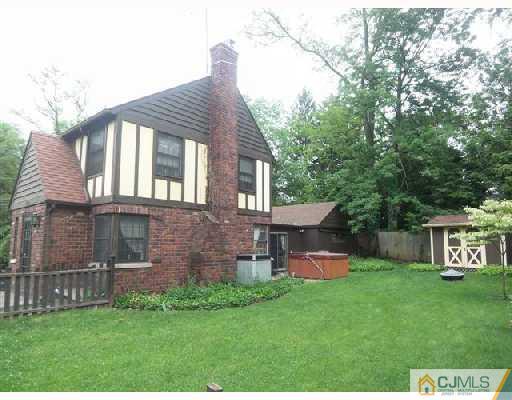 439 Chain O' Hills Road Colonia, NJ 07067 - Photo 10 of 10 a view of a house with a yard and a large tree
