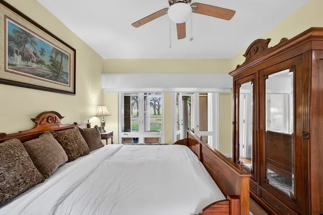 a bedroom with a bed and a large window