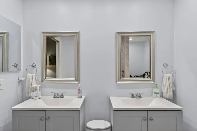 a bathroom with a sink toilet and mirror
