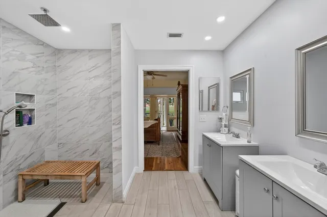 a bathroom with a sink a toilet a mirror and window