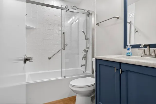 a bathroom with a sink toilet and shower