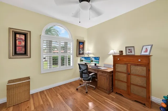 a view of a workspace with furniture and a window