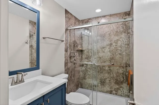 a bathroom with a sink toilet and shower