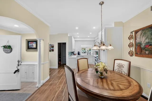 a dining room with furniture and wooden floor