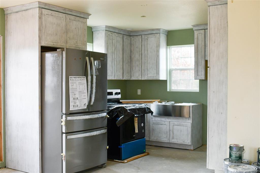 8505 County Road 500 Blue Ridge, TX 75424 - Photo 32 of 39 a kitchen with stainless steel appliances granite countertop a refrigerator a sink and a stove