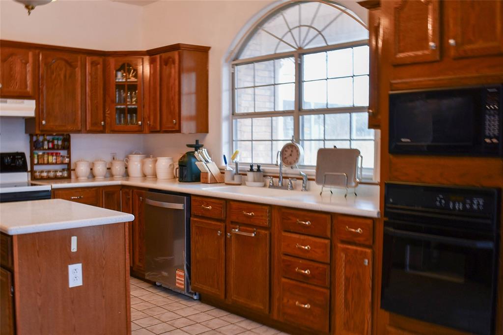 8505 County Road 500 Blue Ridge, TX 75424 - Photo 7 of 39 a kitchen with stainless steel appliances granite countertop a sink stove and cabinets