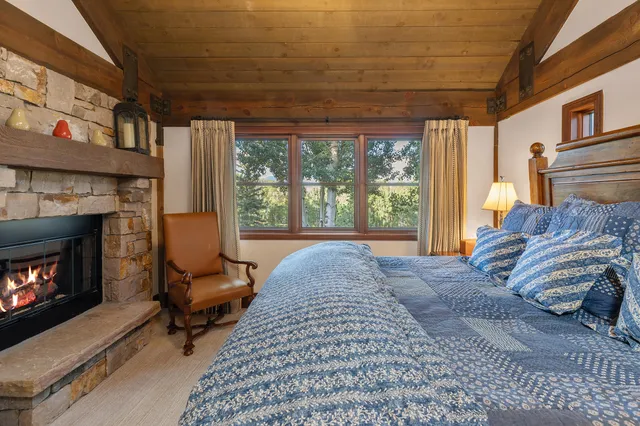 a bed room with a bed and a large window