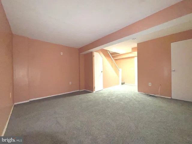 an empty room with a empty space and windows