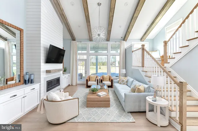 a living room with furniture a flat screen tv and a large window