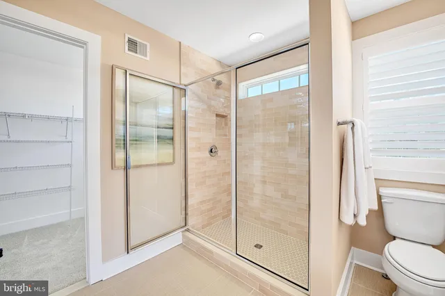a bathroom that has a glass shower door