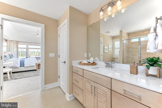 a spacious en suite bathroom with double sink and shower
