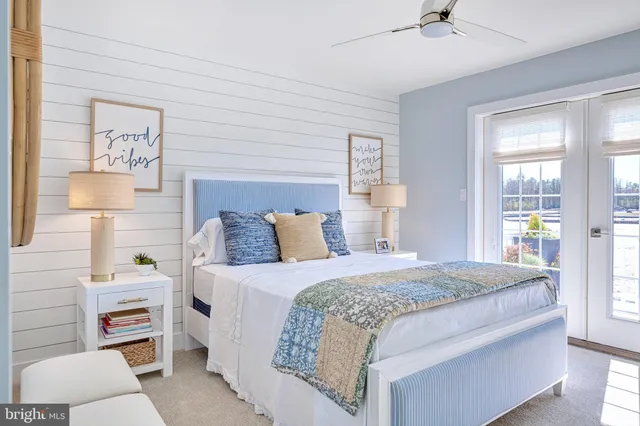 a bedroom with a bed and a lamp on dresser