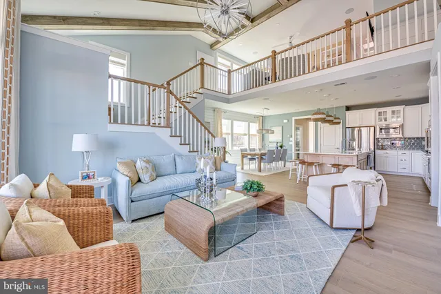 a living room with furniture a rug and a chandelier