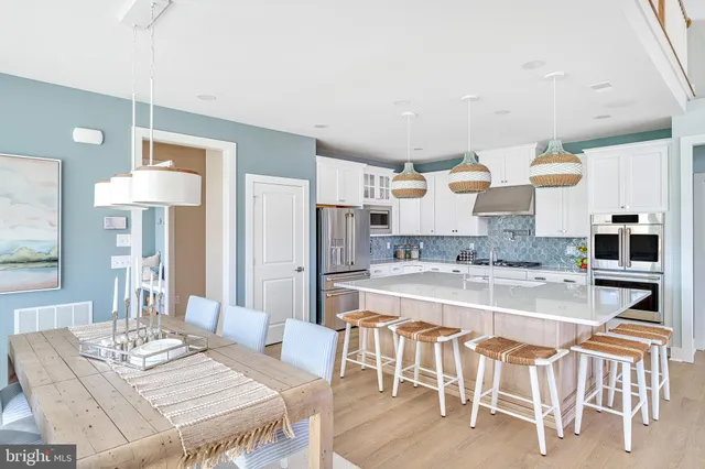 a large kitchen with a table and chairs in it