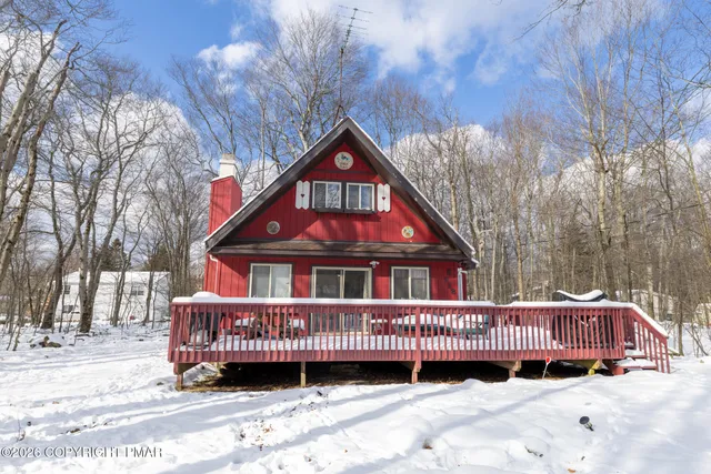a view of a house with a yard and roof deck