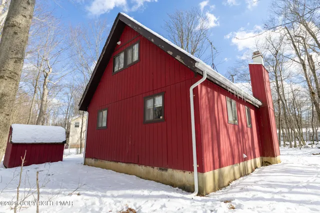 a view of street with trees and covered with snow