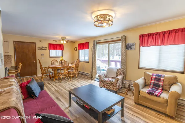 a living room with furniture a rug and a large window