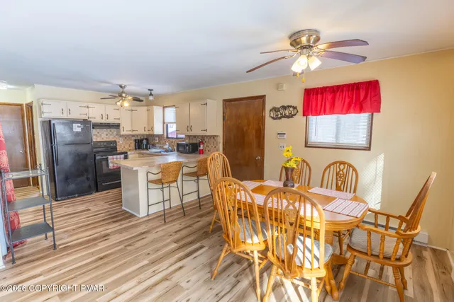 a view of a dining room with furniture and chandelier
