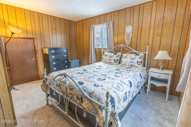 a bedroom with a bed and a dresser