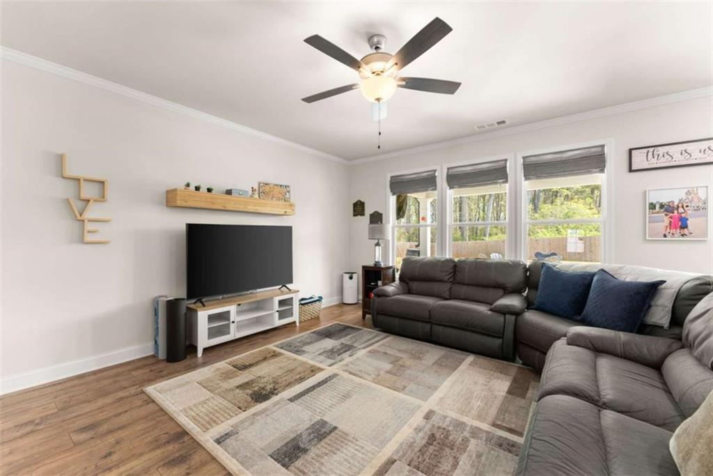 568 Dunagan Court Winder, GA 30680 - Photo 14 of 61 a living room with furniture and a flat screen tv